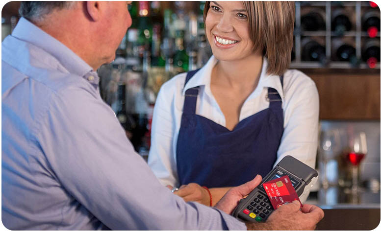 Staff member helps customer with an eftpos payment